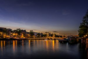 Famous bridge over the river Amstel, the Magere brug, skinny bridge, beautliful at blue hour, Amsterdam, Netherlands