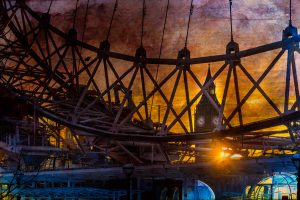 A view through the reels of the London Eye towards Big Ben with the sun going down, London, Great Britain,